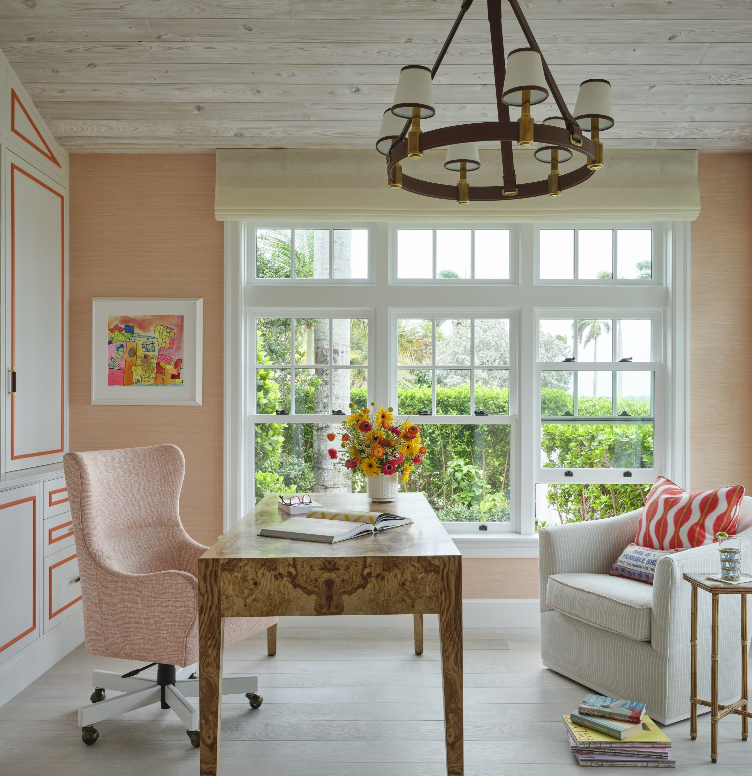 Home office with a burl desk and pink grasscloth walls, by Caitlin Kah
